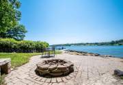 Fire pit and stone patio at lakefront