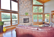 Wood burning floor-to-ceiling stone fireplace